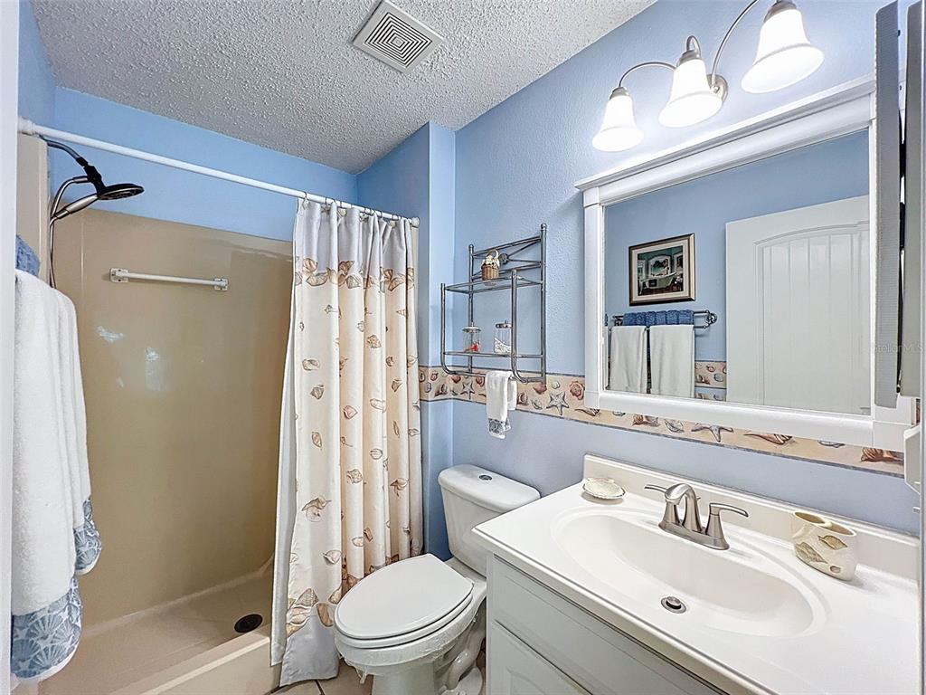 6433 Tina Drive, Unit 12 New Port Richey, FL 34653 - Photo 9 of 24 a bathroom with a sink toilet and shower