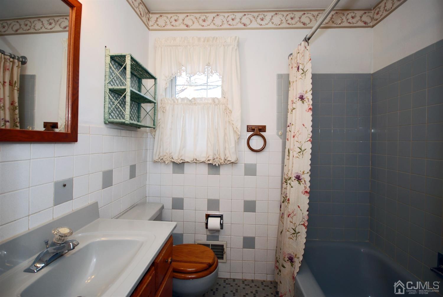 48 Delaware Avenue Middlesex, NJ 08846 - Photo 12 of 15 a bathroom with a sink and a mirror
