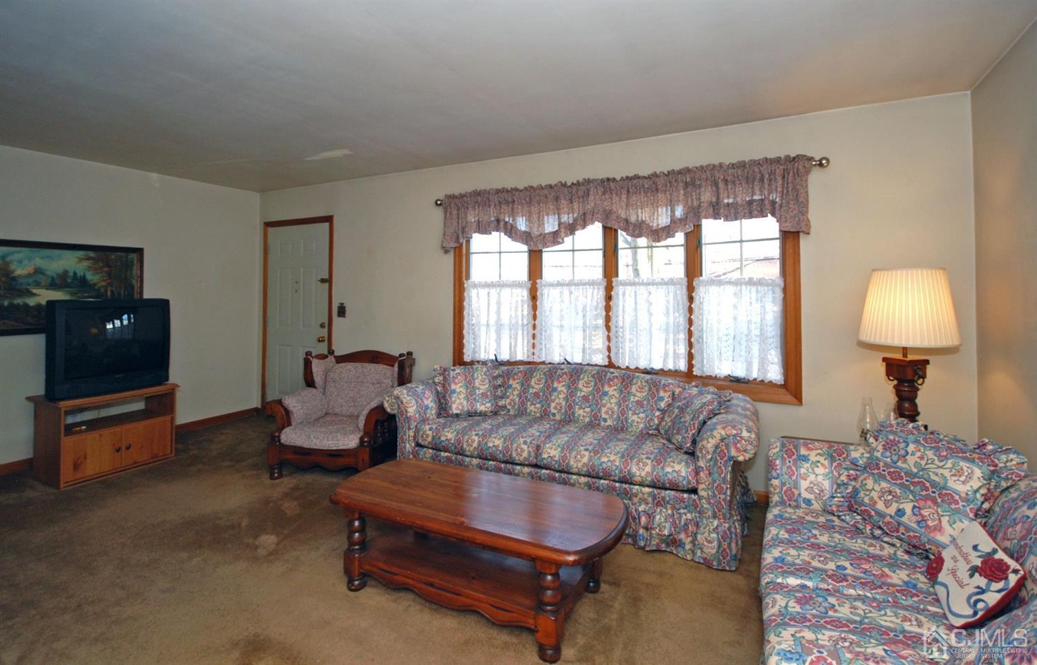 48 Delaware Avenue Middlesex, NJ 08846 - Photo 4 of 15 a living room with furniture and a flat screen tv