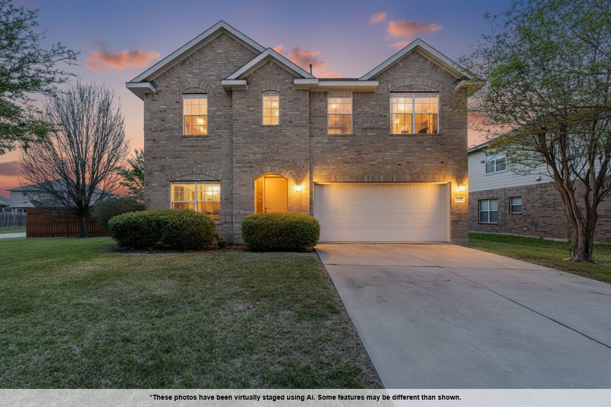 3013 Hawks Swoop Trail Pflugerville, TX 78660 - Photo 2 of 38 Traditional-style house featuring brick siding, concrete driveway, a garage, and a lawn
