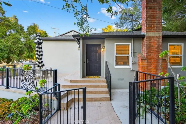 a kitchen with stainless steel appliances granite countertop a dining table chairs refrigerator and microwave