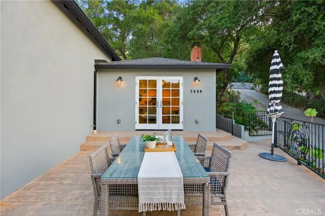 a backyard of a house with table and chairs