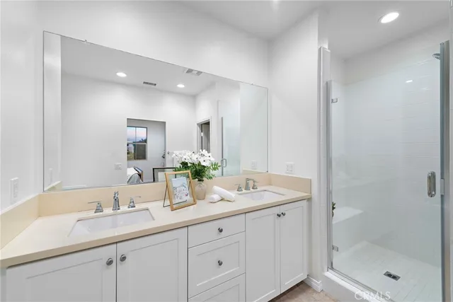 a bathroom with double sink and a mirror