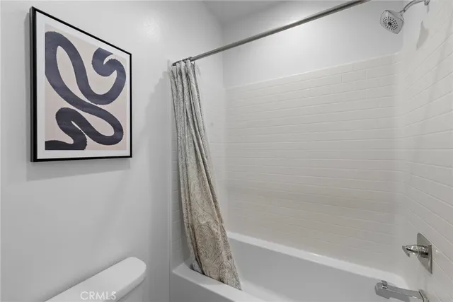 a bathroom with a shower and a toilet