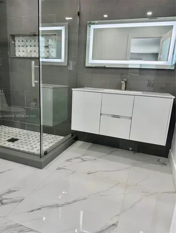 a view of a bathroom with a sink and mirror