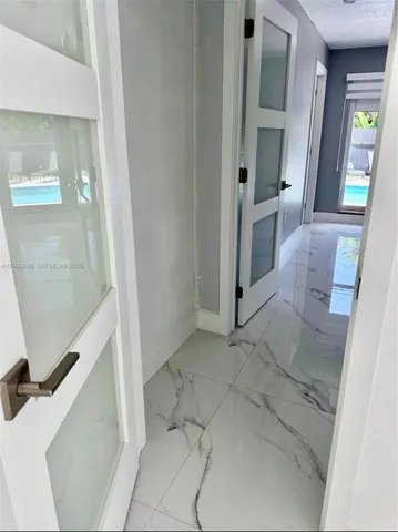 a kitchen with a sink a refrigerator and cabinets