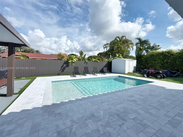 a view of a backyard with sitting area
