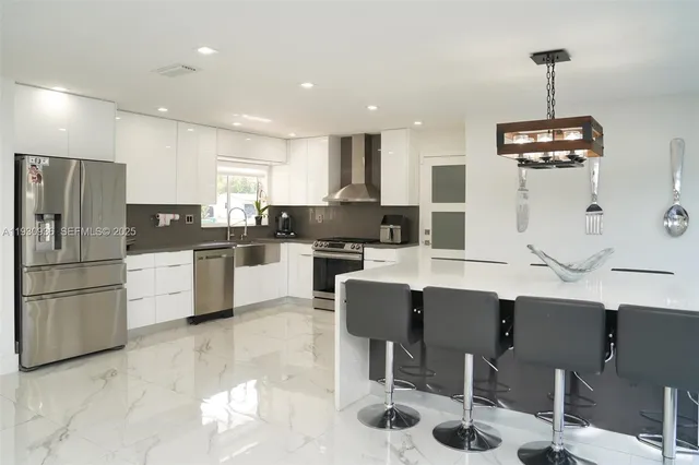 a kitchen with stainless steel appliances kitchen island granite countertop a sink and cabinets
