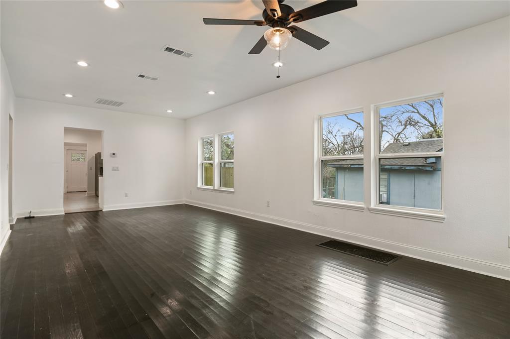 1106 West Chestnut Street Denison, TX 75020 - Photo 19 of 38 Spare room featuring ceiling fan and dark hardwood / wood-style flooring