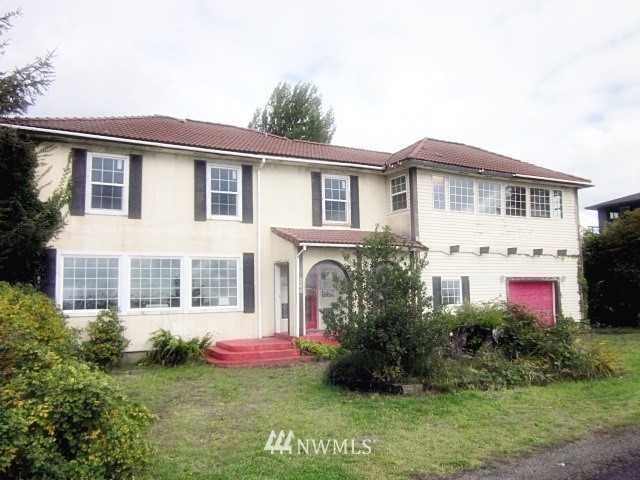 266 Stringtown Road Ilwaco, WA 98624 - Photo 1 of 13 a front view of a house with a garden and plants