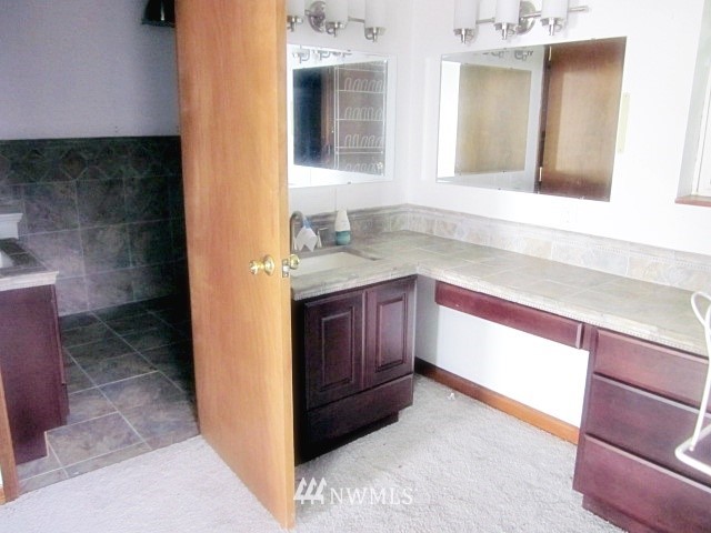 266 Stringtown Road Ilwaco, WA 98624 - Photo 13 of 13 a bathroom with a sink and a mirror