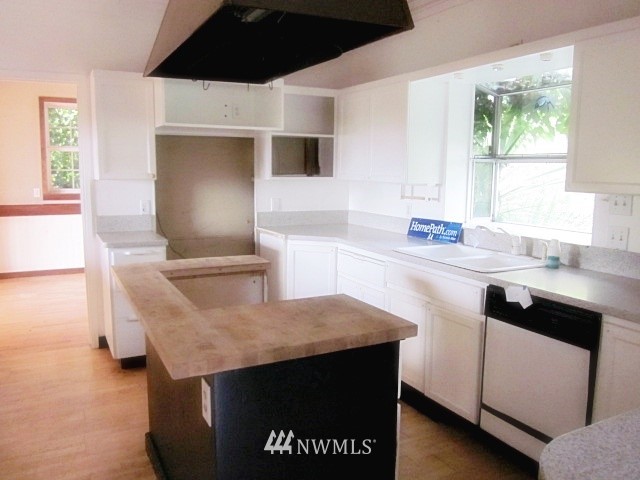 266 Stringtown Road Ilwaco, WA 98624 - Photo 4 of 13 a kitchen with granite countertop a sink a stove and a microwave