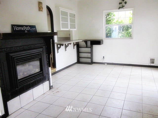 266 Stringtown Road Ilwaco, WA 98624 - Photo 5 of 13 a kitchen with granite countertop a stove a white cabinet and a black granite counter tops