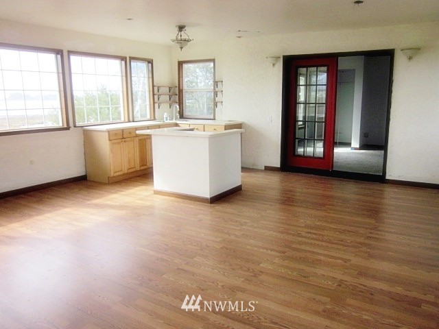 266 Stringtown Road Ilwaco, WA 98624 - Photo 7 of 13 a view of an empty room with window and wooden floor