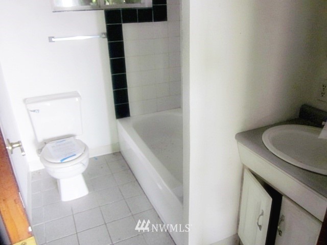 266 Stringtown Road Ilwaco, WA 98624 - Photo 9 of 13 a white toilet sitting next to a bathroom sink
