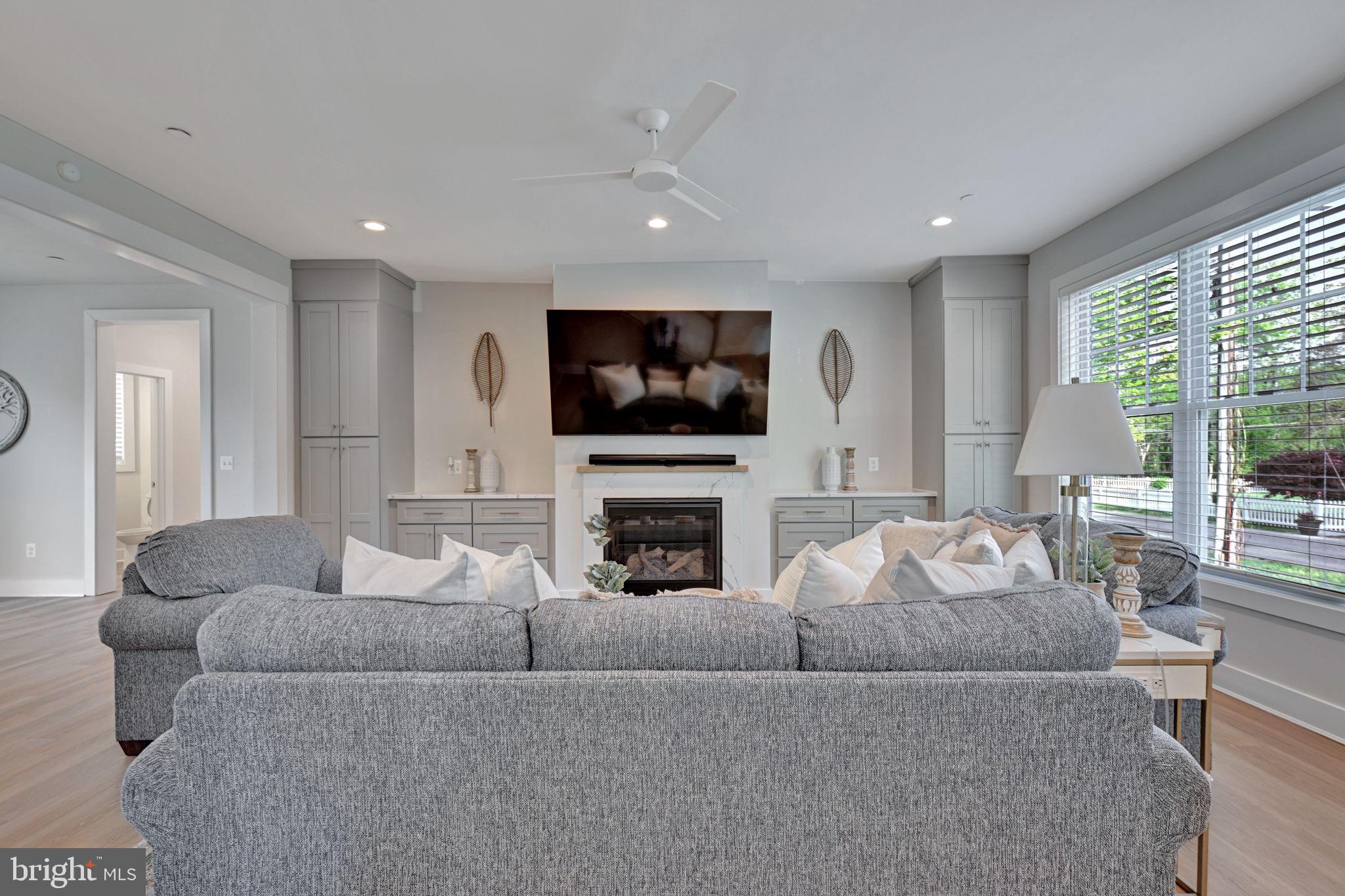 1205 Hawthorne Street Shady Side, MD 20764 - Photo 11 of 35 a living room with furniture a fireplace and a flat screen tv