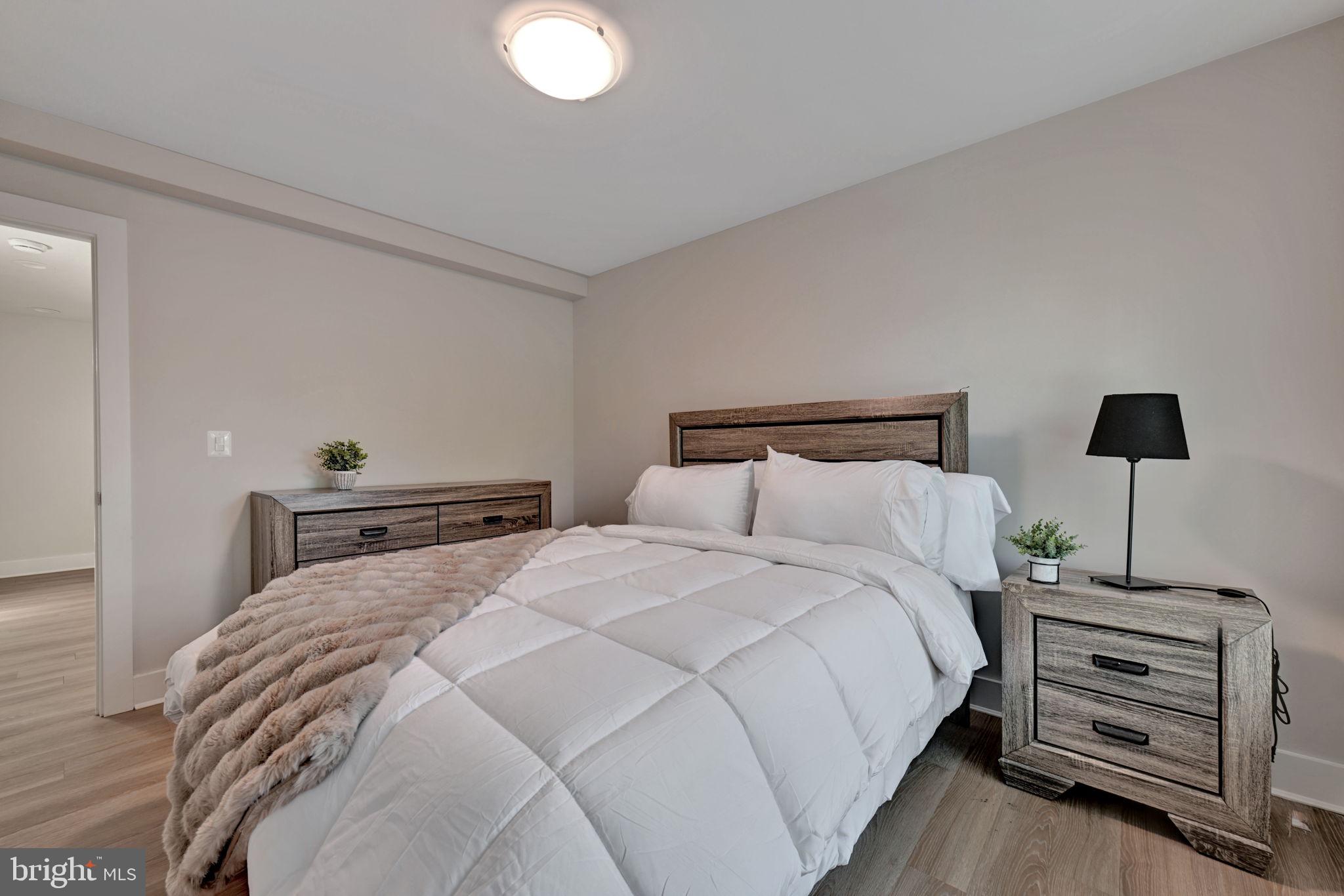 1205 Hawthorne Street Shady Side, MD 20764 - Photo 14 of 35 a bedroom with a bed and a night stand
