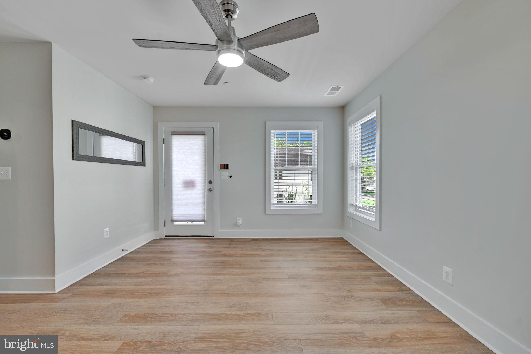 1205 Hawthorne Street Shady Side, MD 20764 - Photo 16 of 35 a view of an empty room with a window and wooden floor