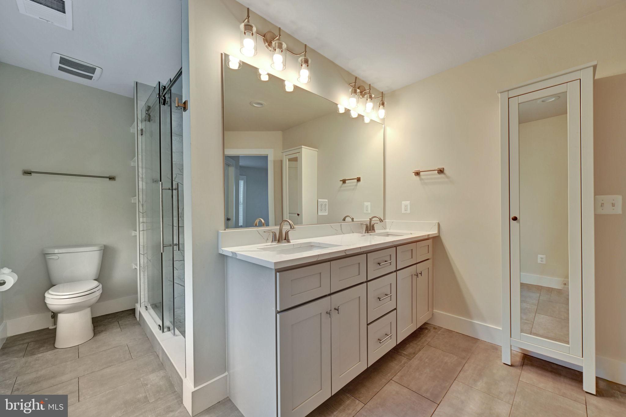 1205 Hawthorne Street Shady Side, MD 20764 - Photo 18 of 35 a bathroom with a double vanity sink mirror and toilet