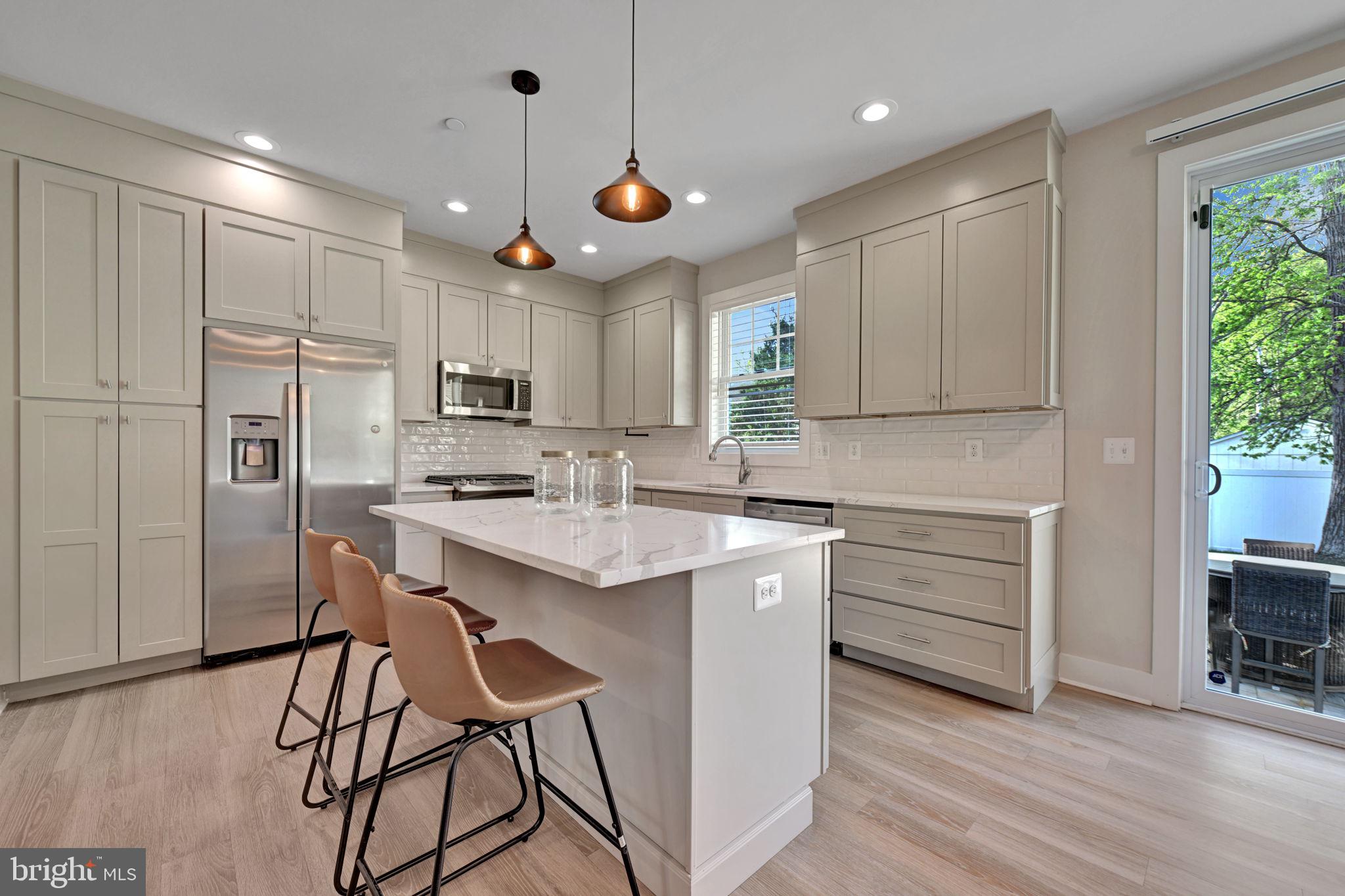 1205 Hawthorne Street Shady Side, MD 20764 - Photo 2 of 35 a kitchen with kitchen island a sink stainless steel appliances and cabinets