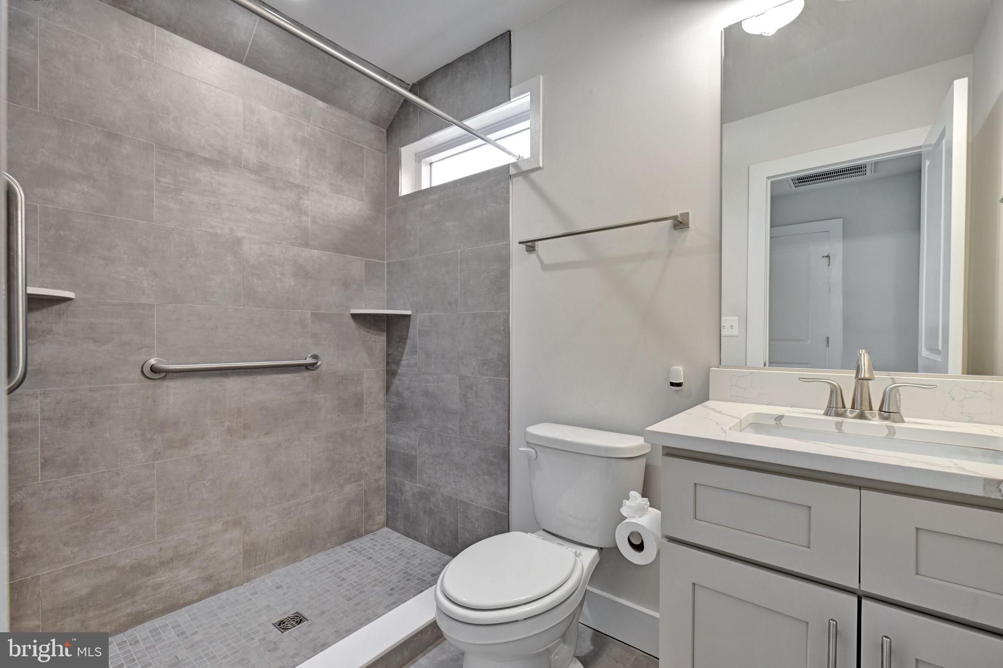1205 Hawthorne Street Shady Side, MD 20764 - Photo 21 of 35 a bathroom with a sink a toilet and shower
