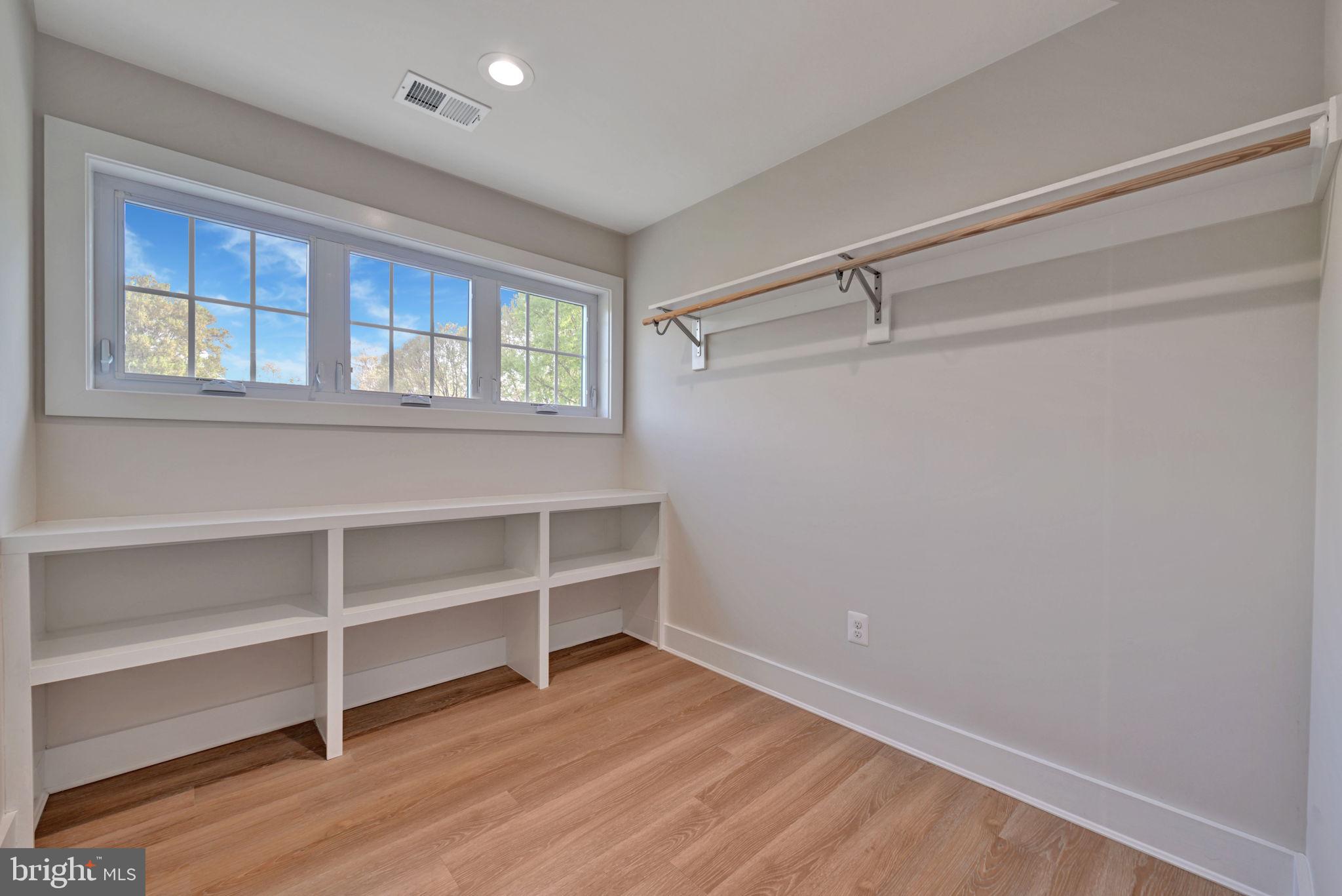 1205 Hawthorne Street Shady Side, MD 20764 - Photo 22 of 35 a view of an empty room with a window and wooden floor