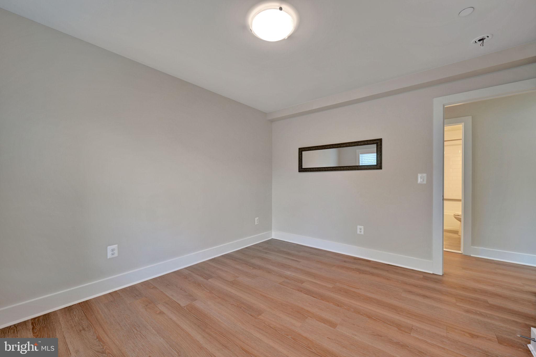 1205 Hawthorne Street Shady Side, MD 20764 - Photo 24 of 35 an empty room with wooden floor and windows