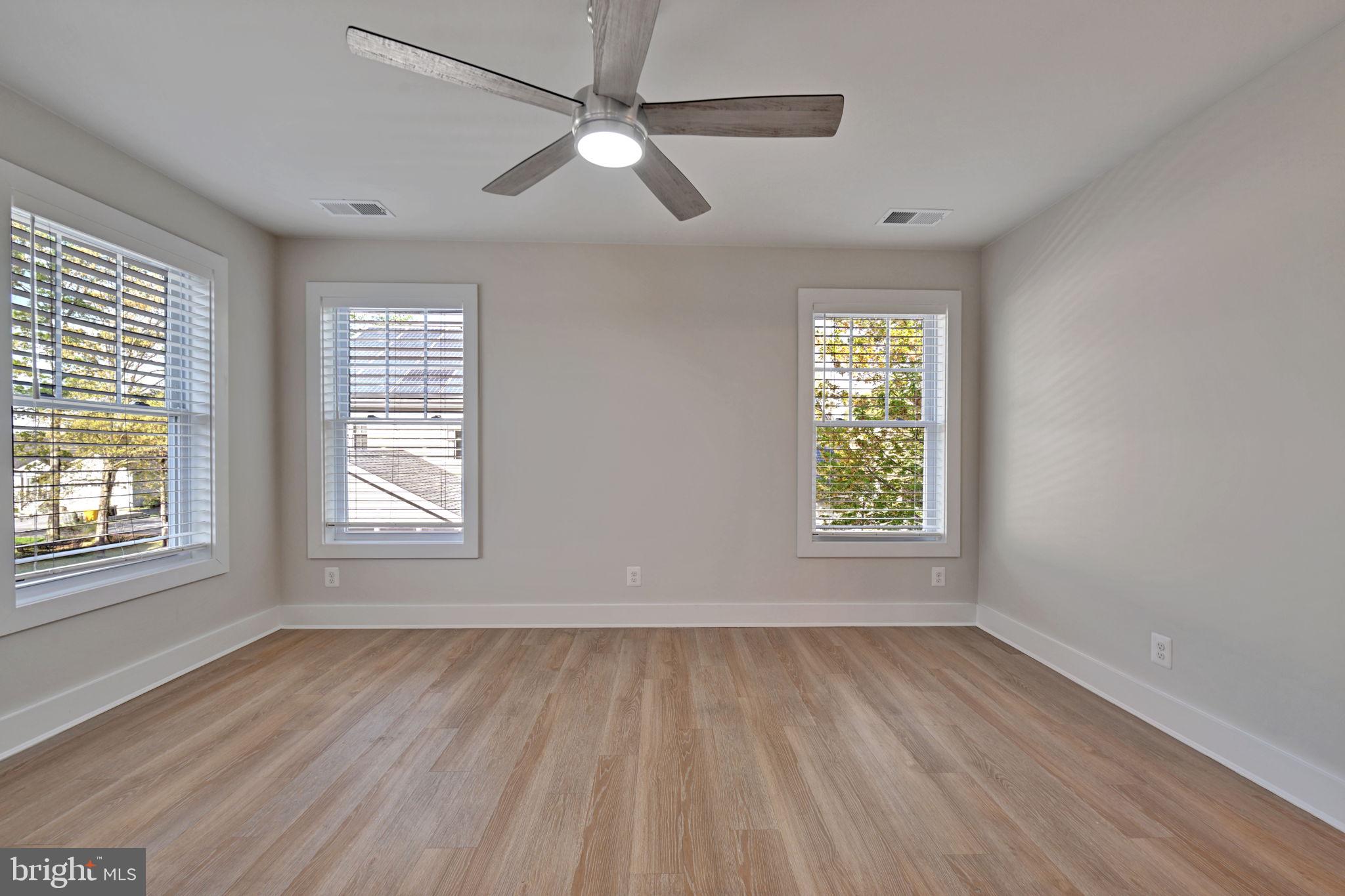 1205 Hawthorne Street Shady Side, MD 20764 - Photo 26 of 35 a view of an empty room with wooden floor and a window