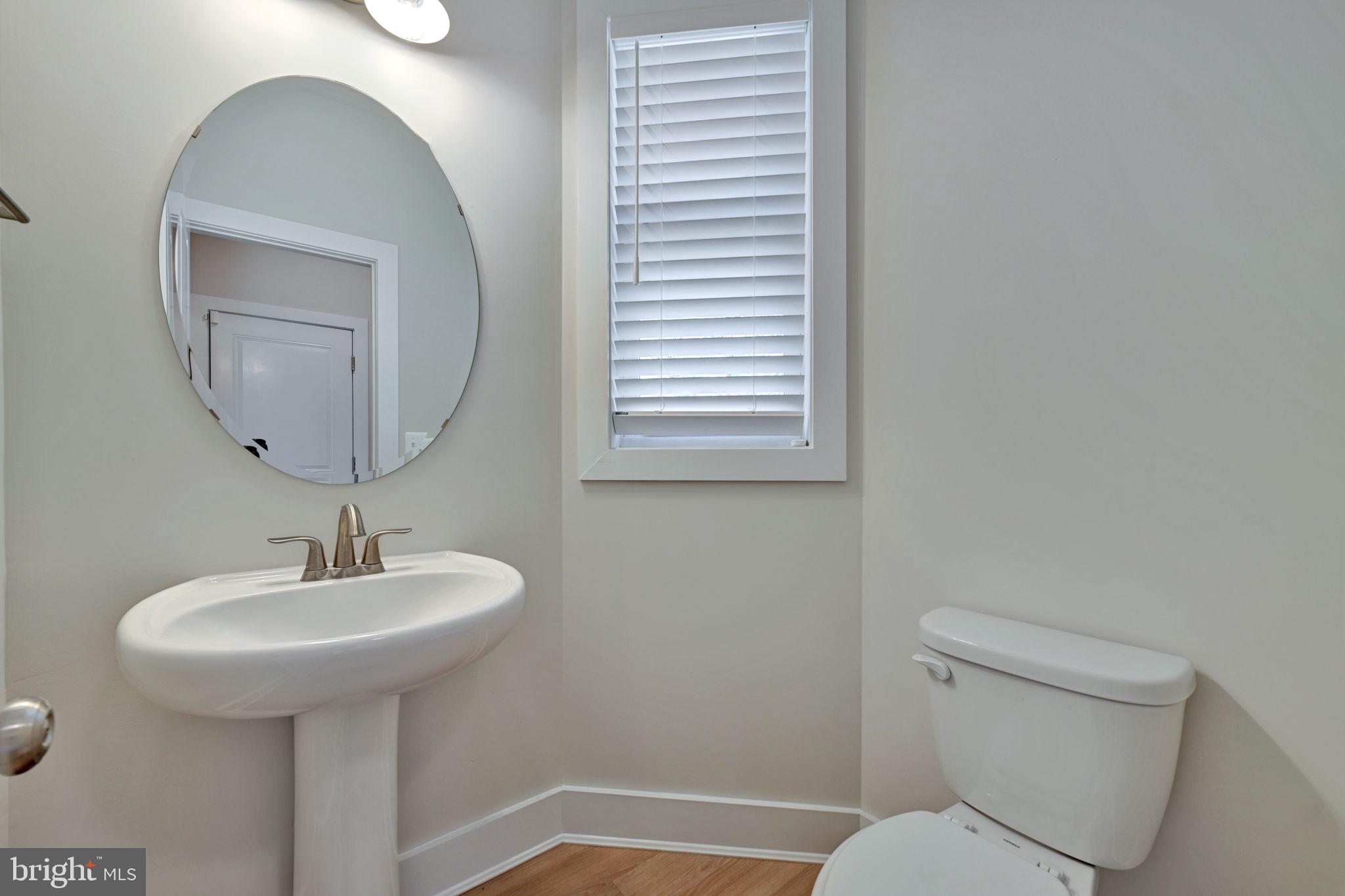 1205 Hawthorne Street Shady Side, MD 20764 - Photo 27 of 35 a bathroom with a toilet sink and mirror