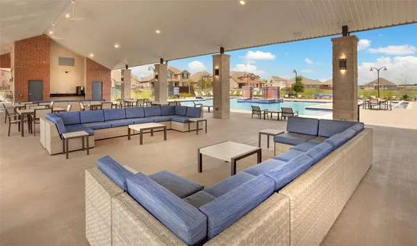 a large pool table and chairs in a patio