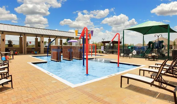 a view of a swimming pool with outdoor seating