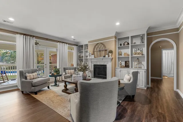 a living room with furniture a fireplace and a window