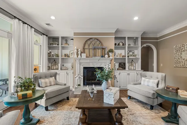a view of a dining room with furniture a chandelier and wooden floor