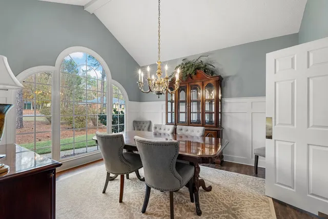 a kitchen with stainless steel appliances granite countertop a stove and a view of living room