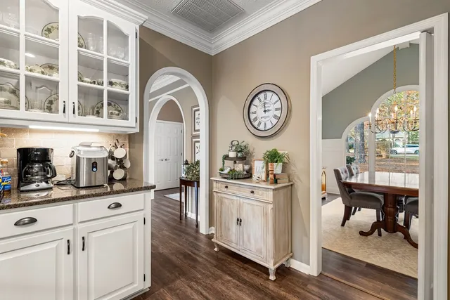 a large kitchen with stainless steel appliances granite countertop a lot of counter space and wooden floor