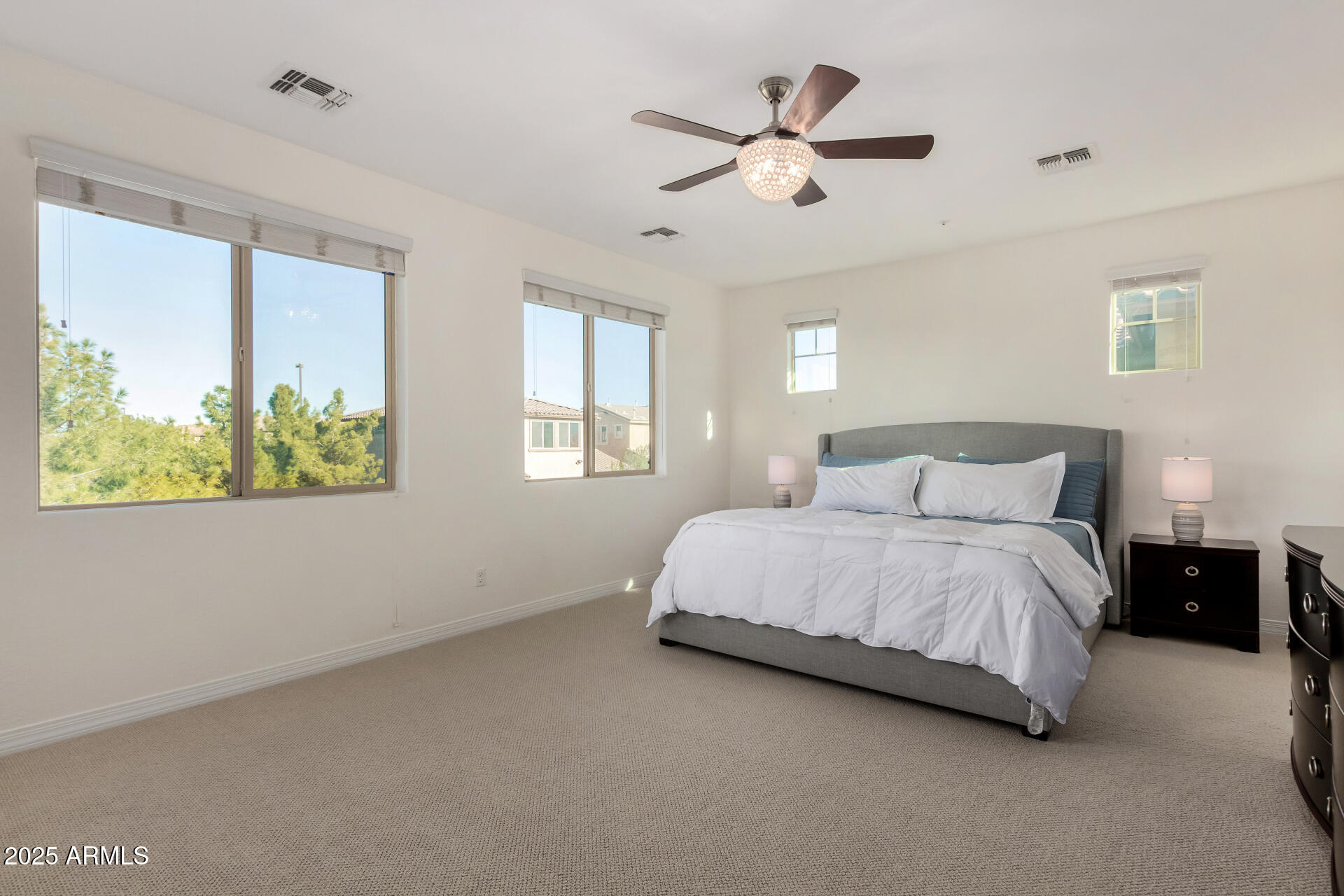 3420 East Indigo Street Gilbert, AZ 85298 - Photo 13 of 27 a bedroom with a bed chandelier and window