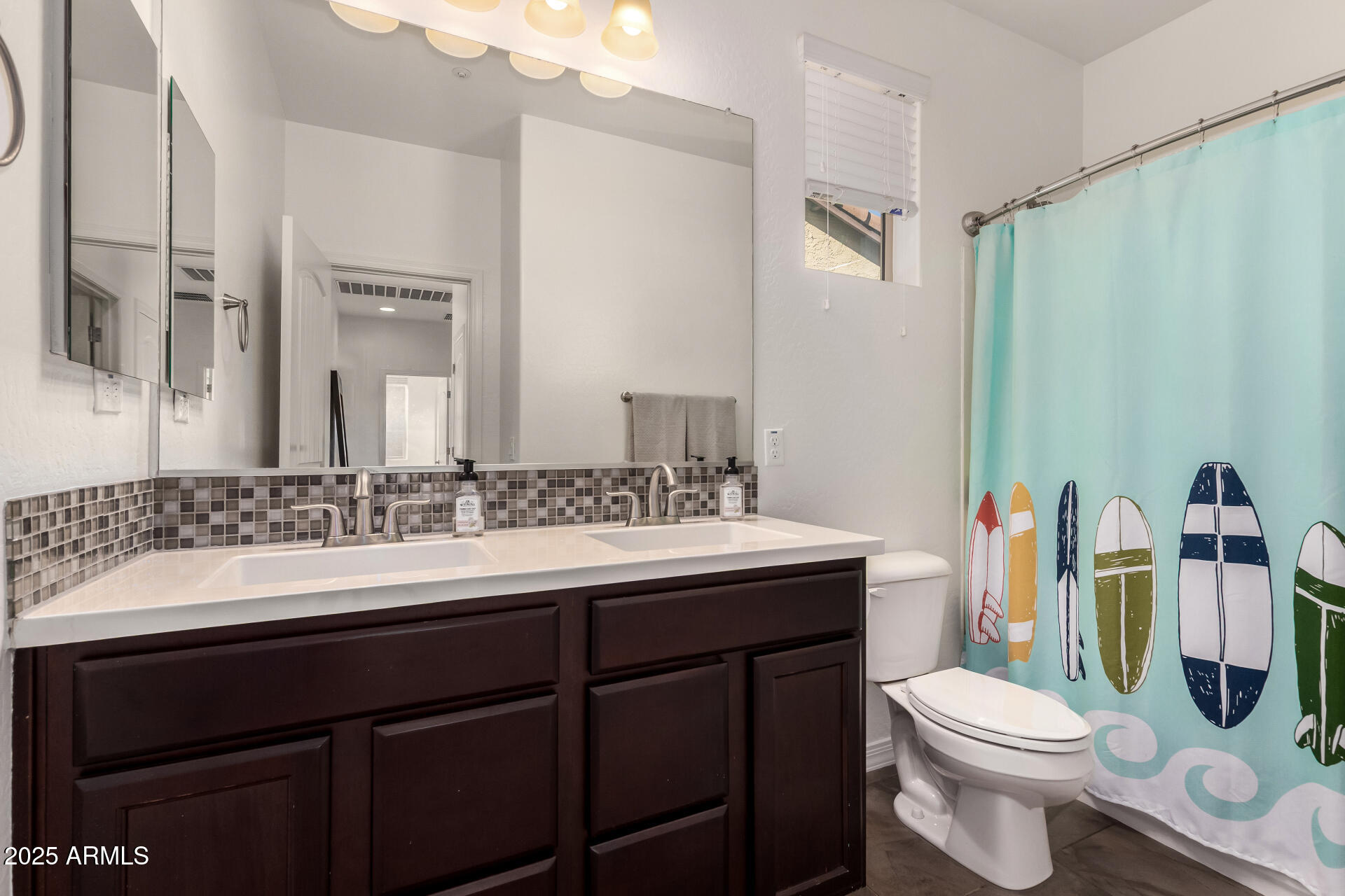 3420 East Indigo Street Gilbert, AZ 85298 - Photo 19 of 27 a bathroom with a sink vanity mirror and toilet