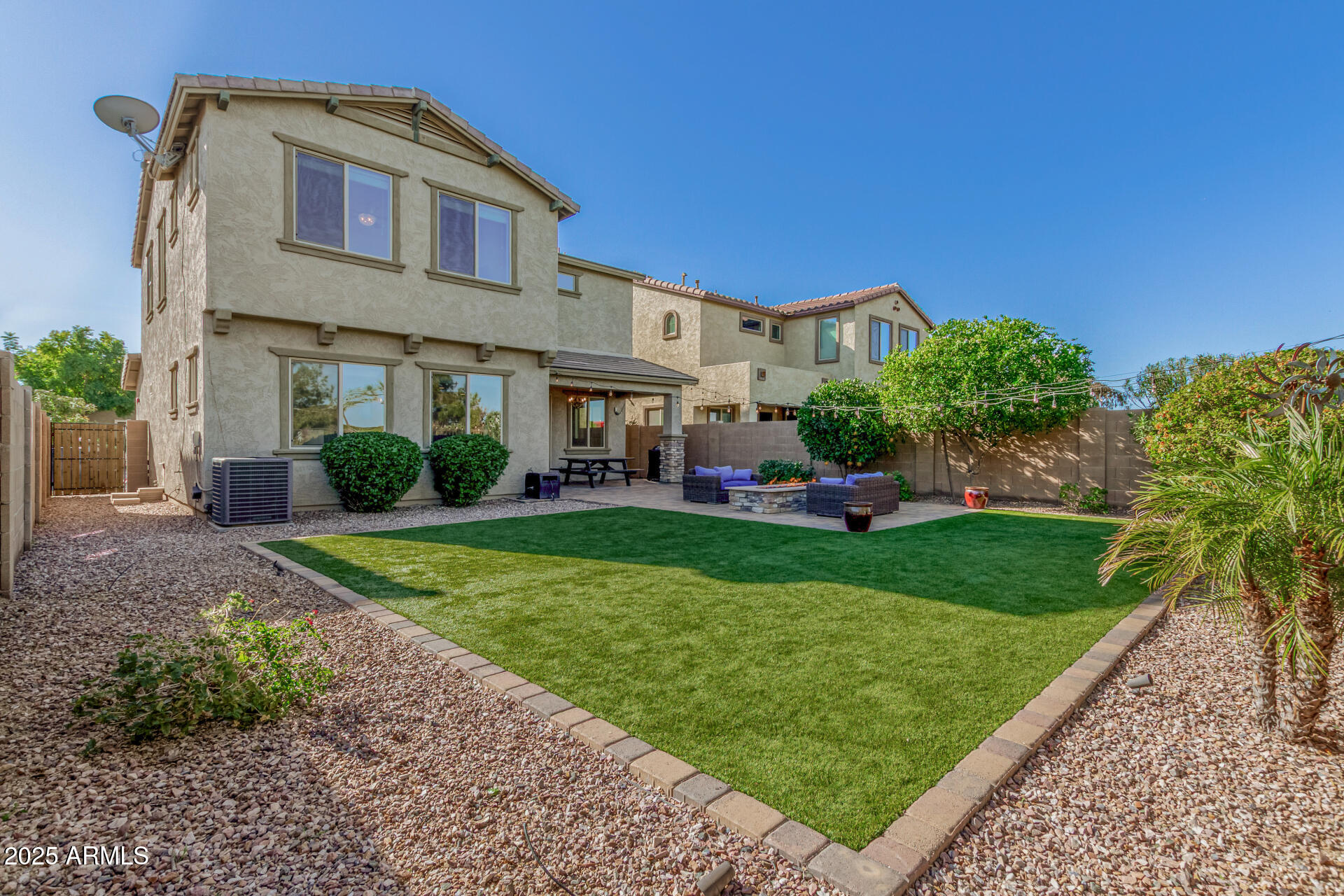 3420 East Indigo Street Gilbert, AZ 85298 - Photo 4 of 27 a front view of a house with a yard and potted plants