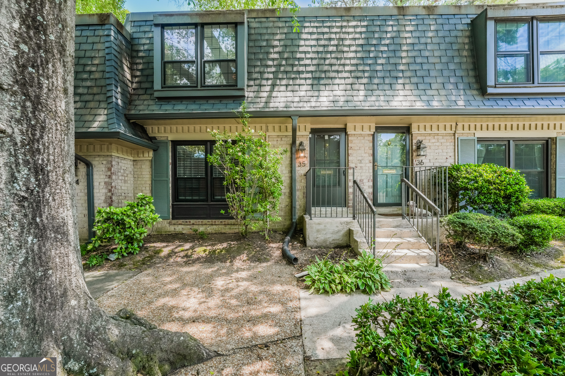 a front view of a building with garden