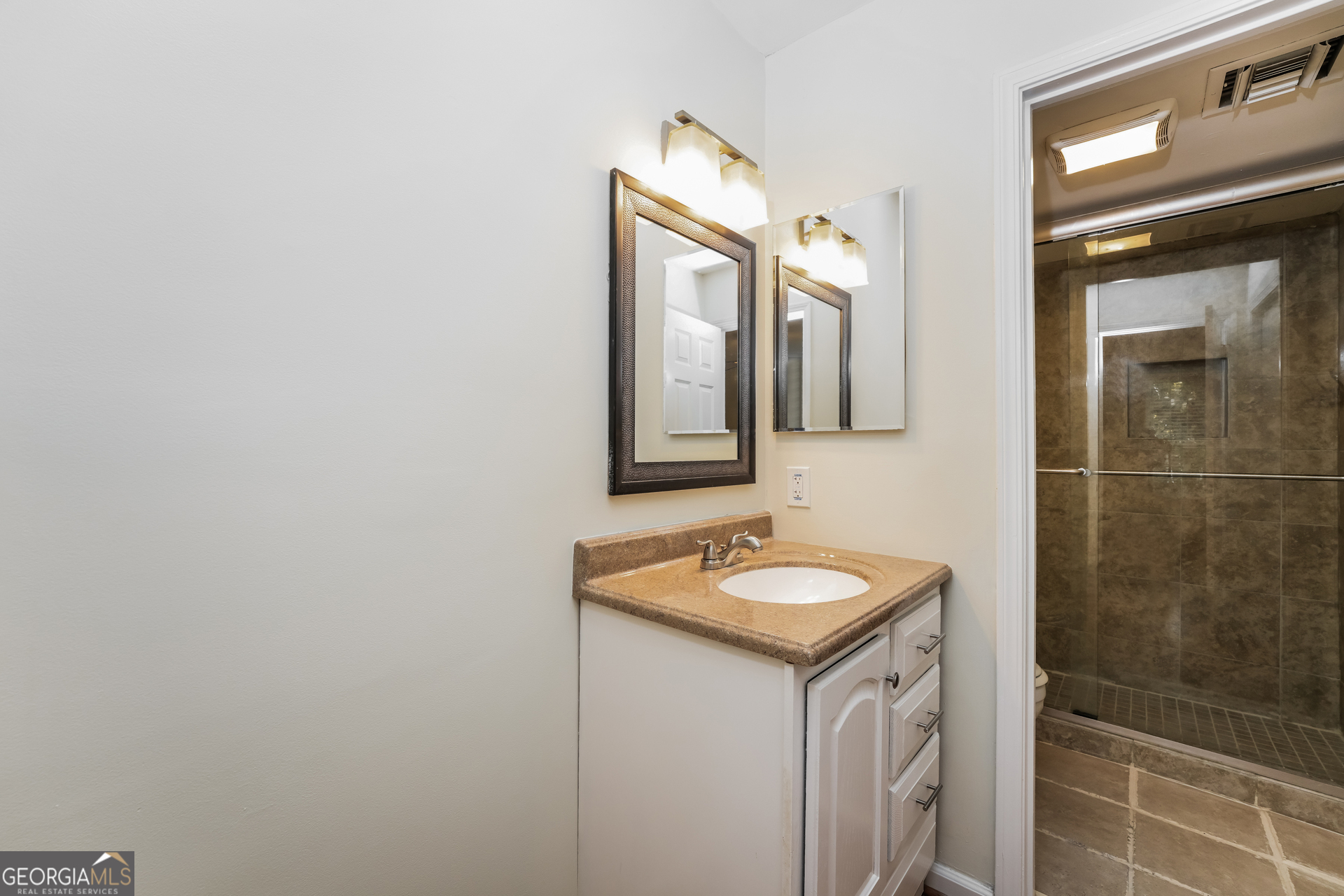 35 La Rue Place Northwest Atlanta, GA 30327 - Photo 11 of 20 a bathroom with a sink and a mirror