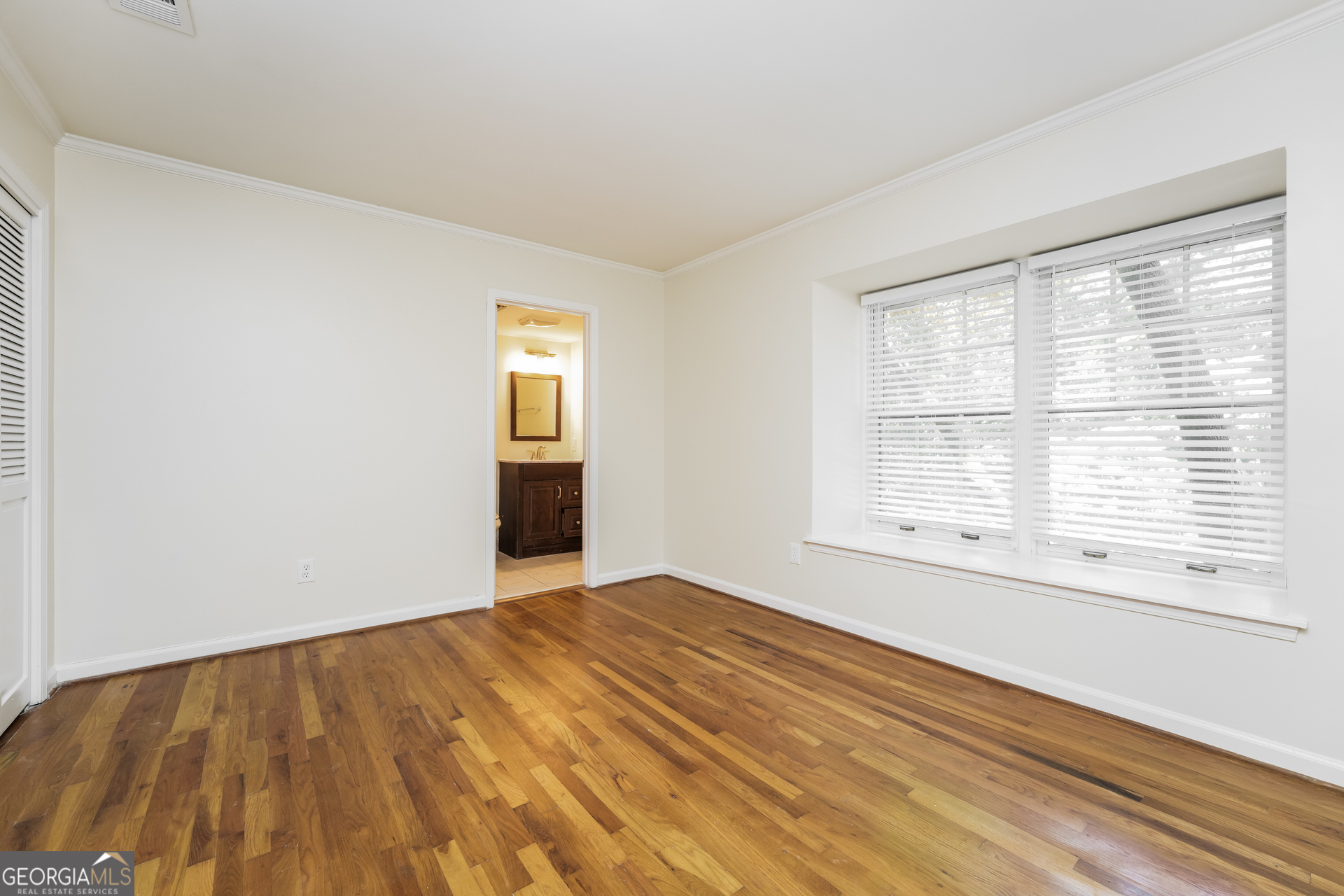 35 La Rue Place Northwest Atlanta, GA 30327 - Photo 13 of 20 a view of an empty room with wooden floor and a window