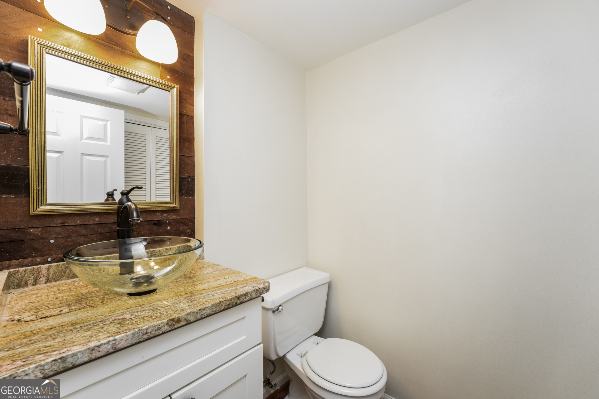 35 La Rue Place Northwest Atlanta, GA 30327 - Photo 15 of 20 a bathroom with a granite countertop toilet sink and mirror