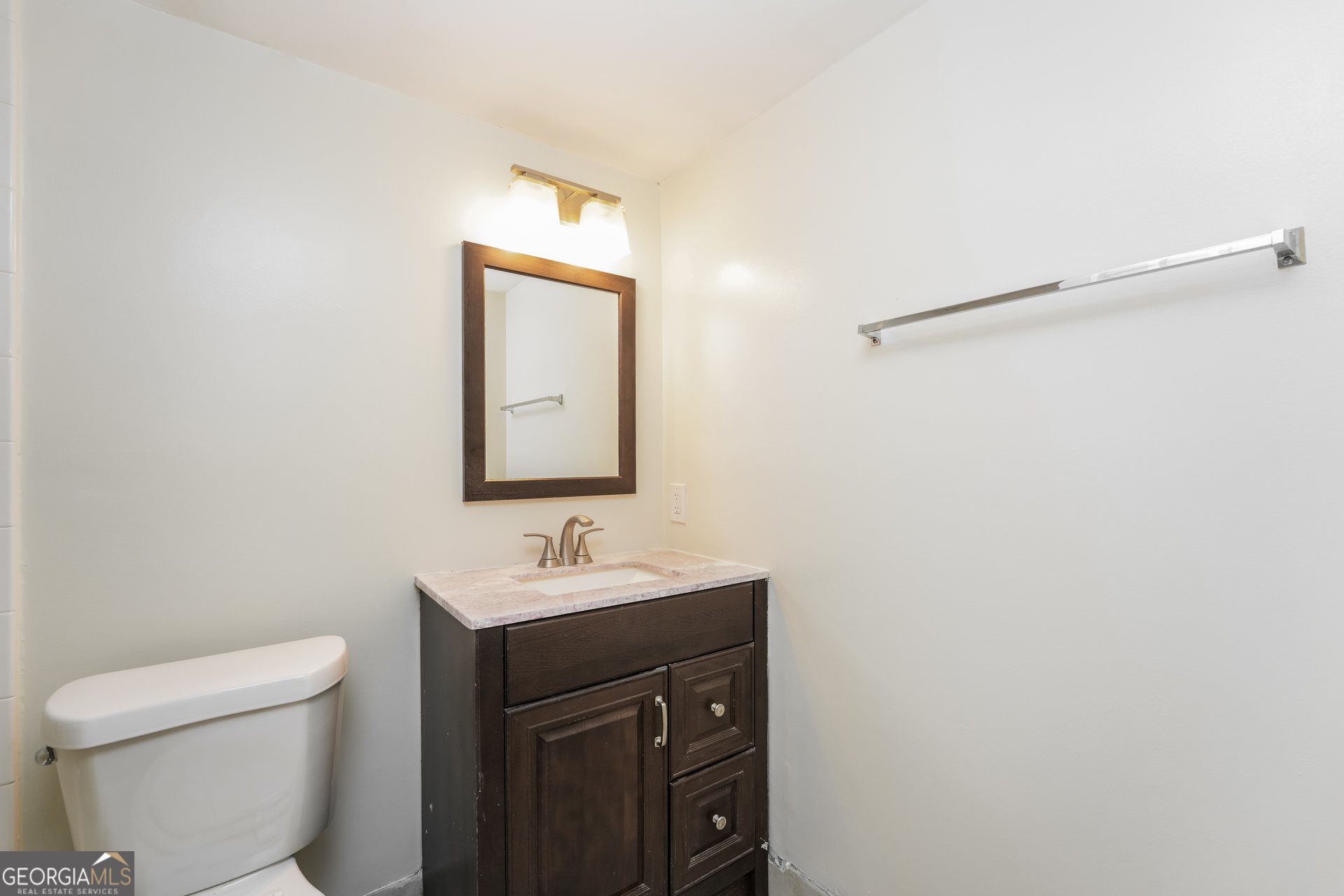 35 La Rue Place Northwest Atlanta, GA 30327 - Photo 16 of 20 a bathroom with a sink a toilet and mirror