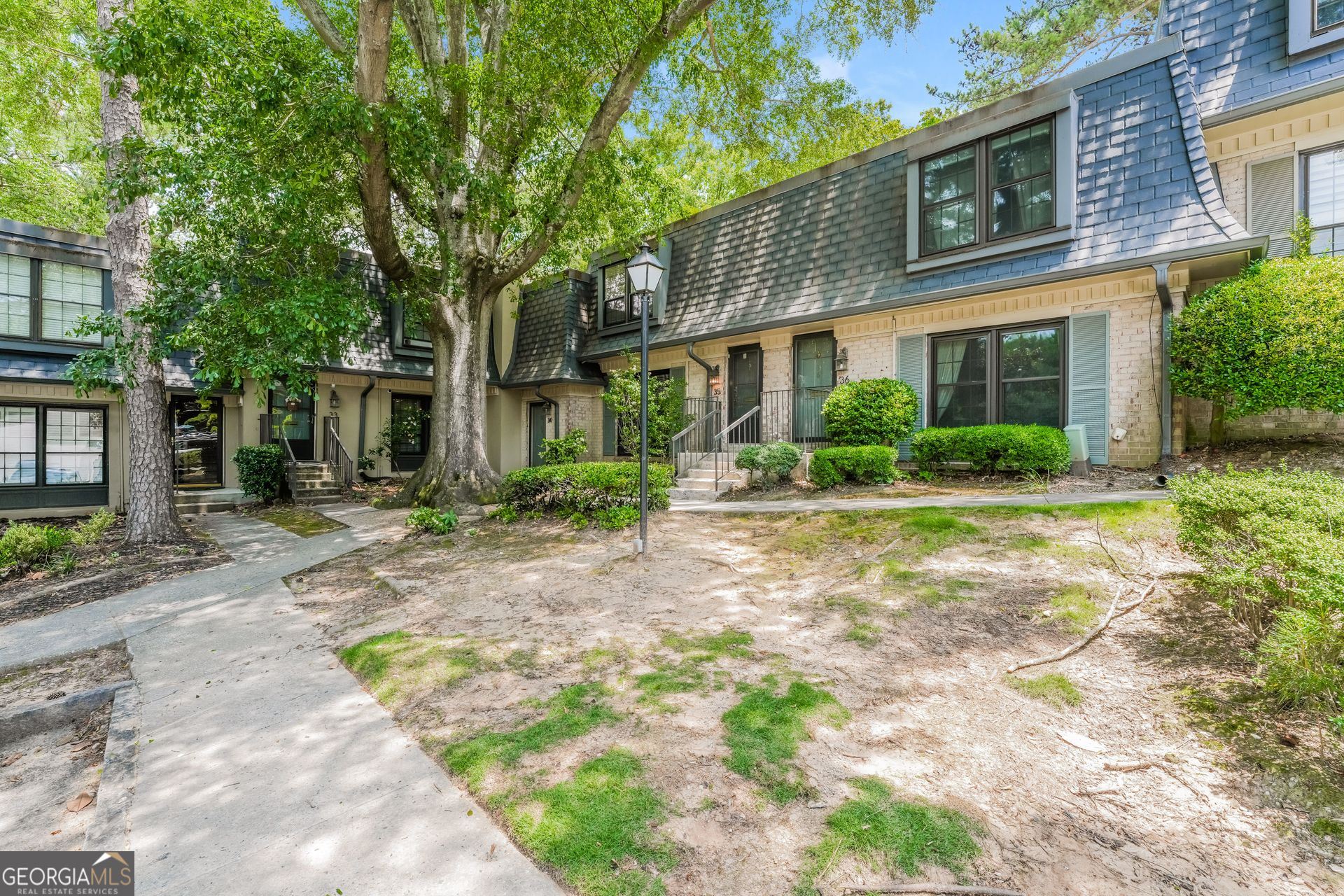 35 La Rue Place Northwest Atlanta, GA 30327 - Photo 2 of 20 a front view of a house with garden and trees