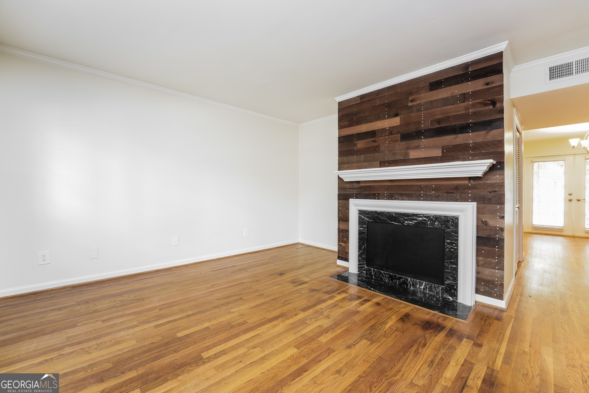 35 La Rue Place Northwest Atlanta, GA 30327 - Photo 3 of 20 a view of empty room with wooden floor and fireplace