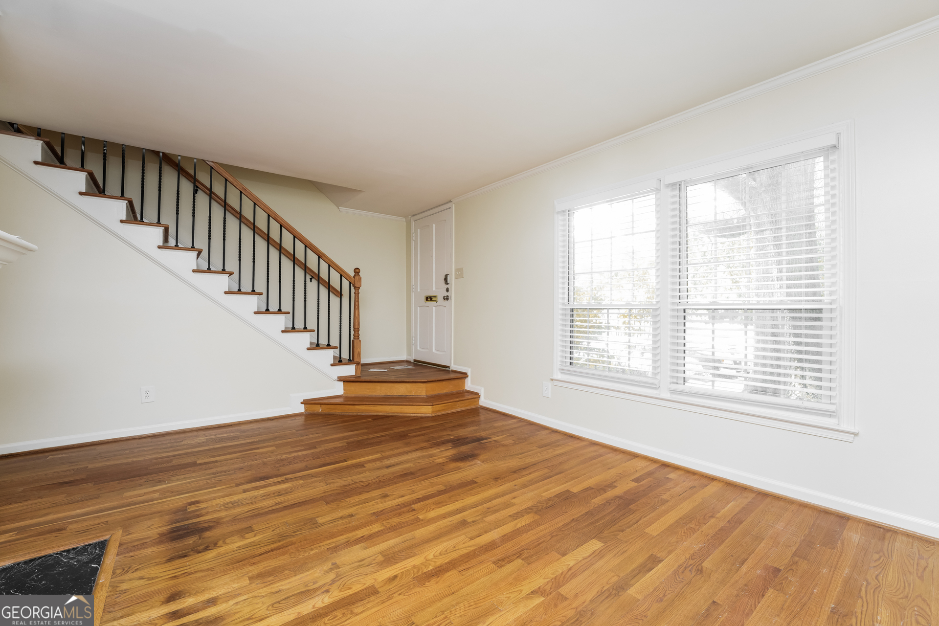 35 La Rue Place Northwest Atlanta, GA 30327 - Photo 4 of 20 a view of an empty room with wooden floor and a window