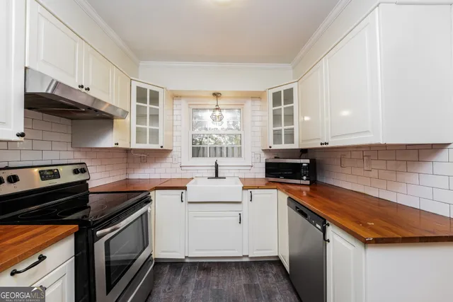 a kitchen with a sink stove and cabinets