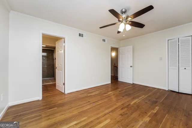 a view of an empty room with wooden floor