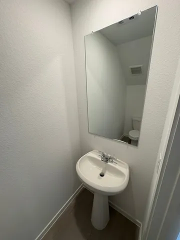 a bathroom with a sink and mirror