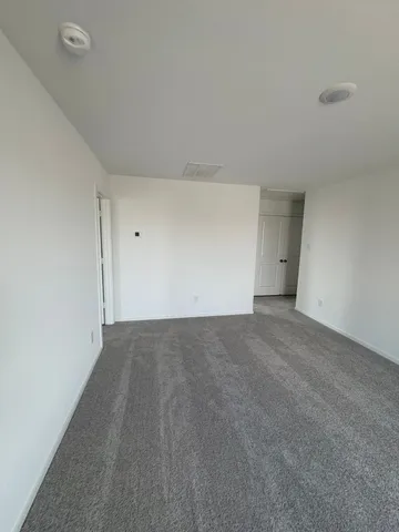a view of an empty room and entryway